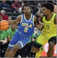  ?? DAVID BECKER - GETTY IMAGES ?? UCLA’S Dylan Andrews drives against Kario Oquendo of Oregon in Thursday’s Pac-12 Tournament game.