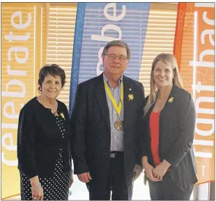  ?? MILLICENT MCKAY/JOURNAL PIONEER ?? From left, Sandra Reeves, cancer survivor; Charles Kelliher, cancer survivor; and Kim Barker, Canadian Cancer Society executive director, pose with Relay flags after Tuesday’s Dream Team announceme­nt.