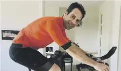  ??  ?? 0 Cyclist Mark Beaumont on the turbo trainer in his living room.