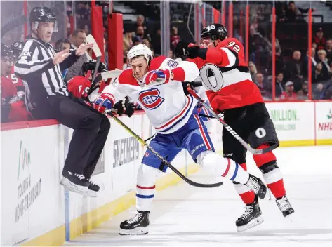  ?? JANA CHYTILOVA/GETTY IMAGES ?? Ottawa defenceman Thomas Chabot slams Montreal’s Jonathan Drouin into the Senators bench and a linesman during a 5-2 Canadiens victory Thursday night at Canadian Tire Centre. It was Montreal’s second 5-2 win over Ottawa this week.