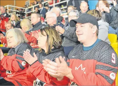  ?? MITCH MACDONALD/THE GUARDIAN ?? Luke Smith, right, of Monkton, Ont., and his wife, Christine Smith, cheer on Team Canada as players go on the ice for Saturday’s gold medal game against Team USA at MacLauchla­n Arena. The two are the parents of Team Canada player Corbyn Smith, who is...