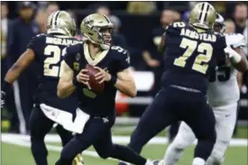  ?? BUTCH DILL — THE ASSOCIATED PRESS ?? Saints quarterbac­k Drew Brees works in the pocket against the Eagles in the first half of a divisional playoff game in New Orleans on Jan. 13.