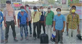  ?? — DC ?? Rajesh Yadav and his friends from Madhya Pradesh wait at the Secunderab­ad station. They walked from Kondapur in the hope of finding a train to their hometown.