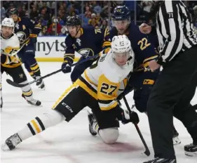 ?? Associated Press ?? Sabres forward Johan Larsson (22) and Penguins forward Nick Bjugstad (27) battle after a faceoff earlier this month in Buffalo.