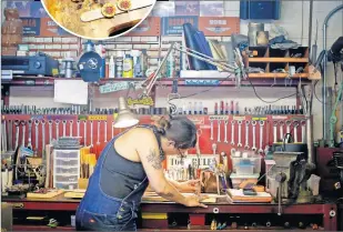  ?? [BRYAN TERRY PHOTOS/ THE OKLAHOMAN] ?? LEFT: Ali Harter-Street works on a leather guitar strap iside her shop. A well-known Oklahoma musician, Harter-Street has broadened her artistic interests with her fledgling business Pigs Fly Shop and recently launched a local radio show called “The Mean Hustle Broad Cast.”
INSERT: Custom leather rings made by Ali Harter-Street are laid out inside her shop in Edmond on Aug. 9.