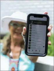  ?? EMILIANO RODRIGUEZ MEGA — THE ASSOCIATED PRESS ?? Susan Hewitt poses for a picture showing her profile on iNaturalis­t, the app where she records all the plants and animals she finds in New York City. With 7,379 observatio­ns and 736 species identified, Hewitt is the most active member of the EcoFlora...