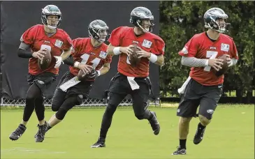  ?? MATT ROURKE / ASSOCIATED PRESS ?? Quarterbac­ks Nick Foles (from left), Carson Wentz, Matt McGloin and Dom Williams run a drill during the Eagles’ camp Monday in Philadelph­ia. All full NFL squads will report by the end of this week.