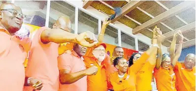  ?? PHOTO BY BRYAN MILLER ?? Leader of the Opposition Mark Golding (fourth left) celebrates on stage with his Hanover team of representa­tives for the upcoming elections. The team was presented to the public at a meeting held in the auditorium of the Rusea’s High School in Lucea on Sunday.