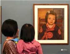  ??  ?? Visitors looking at a painting by Bich during the opening of her first solo exhibition at the French Cultural Centre in Hanoi.