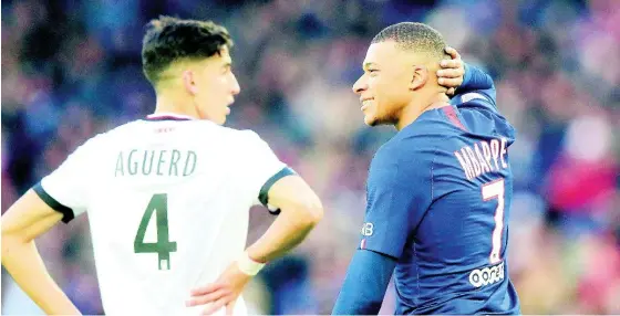 ?? AP ?? PSG’s Kylian Mbappe (right) reacts during the French League One match between Paris-Saint-Germain and Dijon, at the Parc des Princes stadium in Paris, France, Saturday, February 29, 2020.