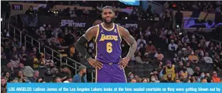  ?? ?? LOS ANGELES: LeBron James of the Los Angeles Lakers looks at the fans seated courtside as they were getting blown out by Phoenix Suns during the second half of the game at Staples Center on Friday in Los Angeles, California.