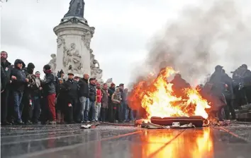  ?? AP ?? A bin burns during a protest in Paris yesterday. France was bracing for fresh violence today following chaos in Paris last weekend with thousands of protesters railing against rising prices.