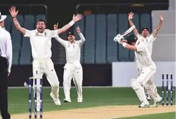  ?? AFP ?? England’s James Anderson (left) and teammates appeal for a leg-before-wicket against Cricket Australia XI’s Nick Larkin on the third day of a four-day tour match at Adelaide Oval.