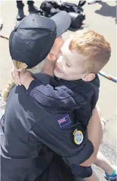  ??  ?? Caitlin Williams has a big hug for Oscar during the visit to the naval base last week.