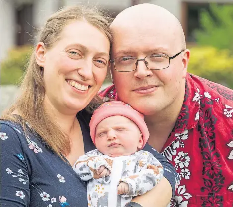  ??  ?? LIFE IS PRECIOUS: Parents Margaret Paluszynsk­a and Richard Winfield with baby Isabella, who was born in April.