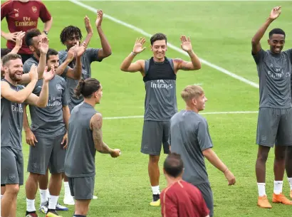  ?? AFP ?? Mesut Ozil (centre) attends a training session with his Arsenal teammates during their pre-season tour for the Internatio­nal Champions Cup match in Singapore. Arsenal take on Atletico Madrid in a friendly on Thursday. —