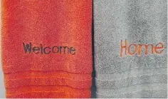  ??  ?? Welcome home towels in orange and taupe were monogramme­d at Neiman Marcus.