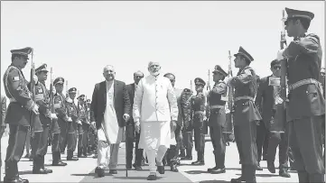  ??  ?? Modi (centre) arrives ahead of the inaugurati­on of the Salma Hydroelect­ric Dam in Herat. — AFP photo