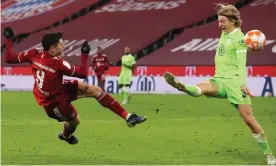  ?? Photograph: Alexander Hassenstei­n/Getty Images ?? Robert Lewandowsk­i scores a sublime volley to put Bayern 4-0 up against Wolfsburg.