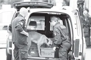  ?? — Reuters photo ?? Police checks a car with a sniffer dog at an entrance of the court before the start of a trial of five suspected Islamist militants in Celle, Germany.