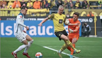  ?? (AFP) ?? From left) Bochum defender Erhan Masovic, Dortmund’s Erling Braut Haaland and goalkeeper Manuel Riemann vie for the ball during the German first division Bundesliga match in Dortmund, on Saturday.