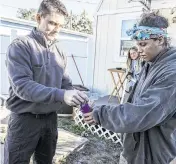  ?? IVY CEBALLO Tampa Bay Times/TNS ?? Ocala Fire Rescue EMS Capt. Jesse Blaire gives medication to Shawnice Slaughter, who is working to recover from a substance use disorder through Florida’s Coordinate­d Opioid Recovery Network, at her home.