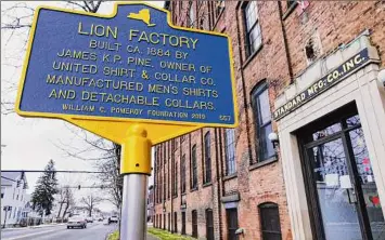  ?? Paul Buckowski / Times Union archive ?? Apparel-making at Standard Manufactur­ing dates back to 1924, and the company once employed over 1,000 workers at multiple locations. As illustrate­d by this historical marker on Second Avenue, however, the industry’s presence in the area goes back even further.