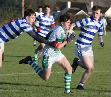  ??  ?? Luke Kavanagh of St. Peter’s darting through a gap between Ian Shanahan and Brendan McDonald.