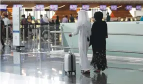 ?? (Reuters) ?? PASSENGERS WALK at Hamad Internatio­nal Airport in Doha, Qatar, yesterday.