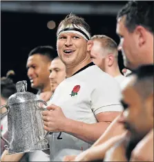  ?? Picture: GETTY IMAGES ?? TROPHY TIME: England’s Dylan Hartley celebrates winning the Calcutta Cup with his teammates after their Six Nations demolition of Scotland at Twickenham in London at the weekend