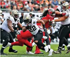  ?? AP Photo/ Mark LoMoglio ?? ■ New Orleans Saints running back Mark Ingram (22) runs against the Tampa Bay Buccaneers during the first half on Dec. 9 in Tampa, Fla. Even a pair of recent road wins haven’t been able to mask a potentiall­y troubling trend for playoff-bound Saints. Their normally prolific offense has been largely stagnant in 10 of their last 12 quarters of play.