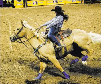  ?? Joel Angel Juarez Las Vegas Review-journal file ?? Hailey Kinsel of Cotulla, Texas,aboard Sister cuts around a barrel in the barrel racing competitio­n atthe2017 Wrangler National Finals Rodeo at the Thomas &amp; Mack Center.