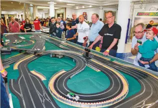  ??  ?? ABOVE From young to old, there were plenty of slot car enthusiast­s all keen to speed around the different tracks at the event. Photograph­s by Rob Tysall.