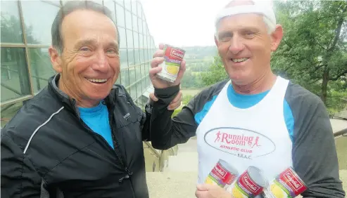  ?? NICK LEES ?? Ken Davison, 73, runs his 100th marathon Aug. 19 in Edmonton, and is pictured here with race organizer John Stanton, as well as Davison’s trusty supply of French-Canadian pea soup, which he eats during races.