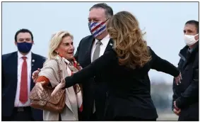  ?? (AP/Patrick Semansky) ?? U.S. Secretary of State Mike Pompeo and his wife, Susan (right), embrace U.S. Ambassador to France Jamie McCourt on Saturday after stepping off a plane in Le Bourget, France.