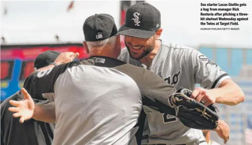  ?? HANNAH FOSLIEN/GETTY IMAGES ?? Sox starter Lucas Giolito gets a hug from manager Rick Renteria after pitching a threehit shutout Wednesday against the Twins at Target Field.