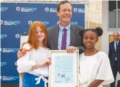  ?? (Olivier Fitoussi/The Jewish Agency for Israel) ?? MATADEL SISAIA, who immigrated from Ethiopia, and Oliana Goodim, who immigrated from Ukraine, give outgoing Jewish Agency chairman Isaac Herzog tips in preparatio­n for moving into the President’s Residence at his farewell event yesterday.