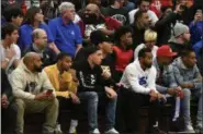  ?? PATRICK HOPKINS - FOR THE NEWS-HERALD ?? LiAngelo Ball and LaVar Ball, center, watch SPIRE play Garfield Heights on Nov. 29 at Euclid.