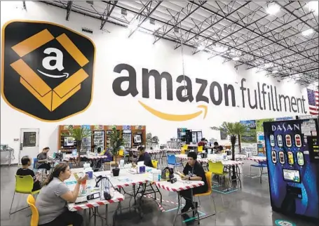  ?? Genaro Molina Los Angeles Times ?? AN AMAZON warehouse in Moreno Valley. Amazon, Google, Facebook and Apple are fighting bills aimed at curbing their market power. Anti-monopoly groups say Big Tech preys on small businesses and makes it impossible for them to operate without the corporatio­ns.