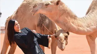  ??  ?? A foreign visitor at the King Abdul Aziz Camel Festival that kicked off on Monday in Riyadh. (AN photo)