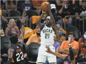  ?? Ross D. Franklin / Associated Press ?? The Bucks’ Jrue Holiday had 27 points, 13 assists and a key defensive play late.