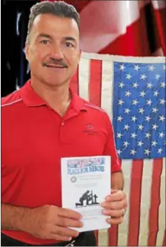  ?? SUBMITTED PHOTO ?? Mark Gibbons, a member of Chichester Rotary Club, purchases the first flag for the Flag for Heroes Program. The Chichester Rotary Club will install flags the week before and after Labor Day weekend, Aug. 30 to Sept. 12, as part of the Flags for Heroes program.