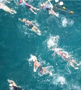  ?? SUNSTAR FOTO / ALLAN CUIZON ?? CURRENT EVENT. A dronemount­ed camera captures some of the 2,500 participan­ts in the 1.8-kilometer swim leg. More photos and stories in Sports, A26 and A27.