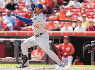  ?? JOHN MINCHILLO/ASSOCIATED PRESS ?? Adrian Gonzalez of the Dodgers hits a homer in the fifth inning against Cincinnati. It was one of his three homers on Monday and one of seven hit by Los Angeles.