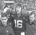  ?? GARY MCCULLOUGH/AP ?? Jaguars quarterbac­k Trevor Lawrence is helped to a stadium tunnel during Monday’s against the Bengals in Jacksonvil­le, Fla.