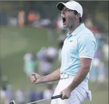  ?? John Bazemore/Associated Press ?? Rory McIlroy reacts after sinking a putt on the fourth hole of a playoff to win the Tour Championsh­ip and the FedEx Cup Sunday at East Lake Golf Club in Atlanta.