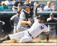  ?? Jim McIsaac / Associated Press ?? The New York Yankees’ Aaron Hicks, right, is tagged out at the plate by Tampa Bay Rays catcher Erik Kratz ending the sixth inning on Saturday.