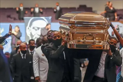 ?? Godofredo A. Vasquez/AFP via Getty Images ?? Pallbearer­s carry the casket following the funeral of George Floyd on Tuesday at The Fountain of Praise church in Houston. The funeral in Floyd’s hometown was the culminatio­n of a long farewell to the 46-year-old African American whose death in police custody ignited global protests against police brutality and racism.