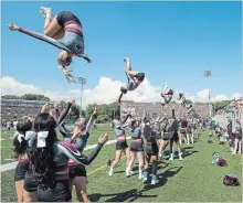  ??  ?? With the offence finally unleashed, things were flying on the sidelines, too, thanks to the McMaster cheerleade­rs.