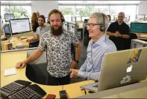  ?? ERICH SCHLEGEL / FOR AMERICAN-STATESMAN 2017 ?? BELOW: Apple CEO Tim Cook (center right), at the Austin campus in August to mark the firm’s 25th year in Austin, talks to a customer with Senior Specialist Andrew Mills.
